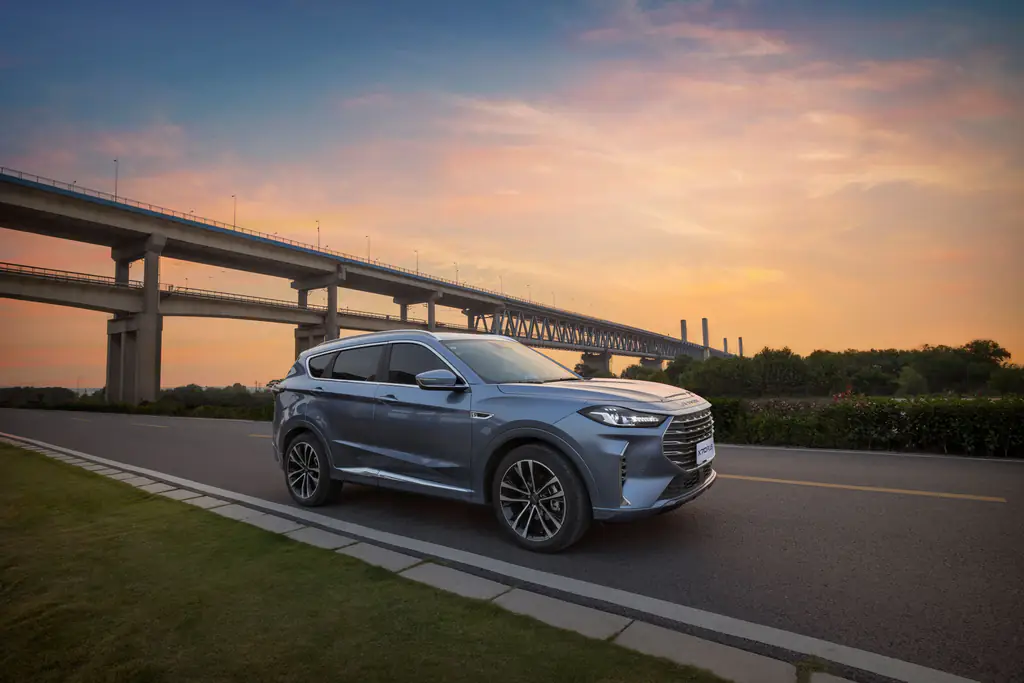 SUV driving on a highway at sunset