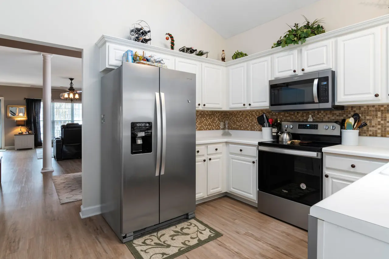 Kitchen with a stainless steel refrigerator, range and microwave